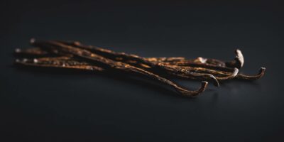 The vanilla pods on a black table.